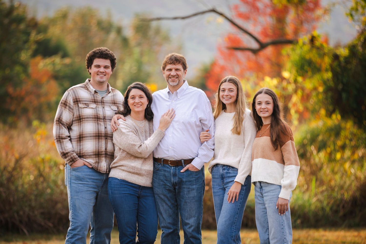 Family session with parents and teen children in fall