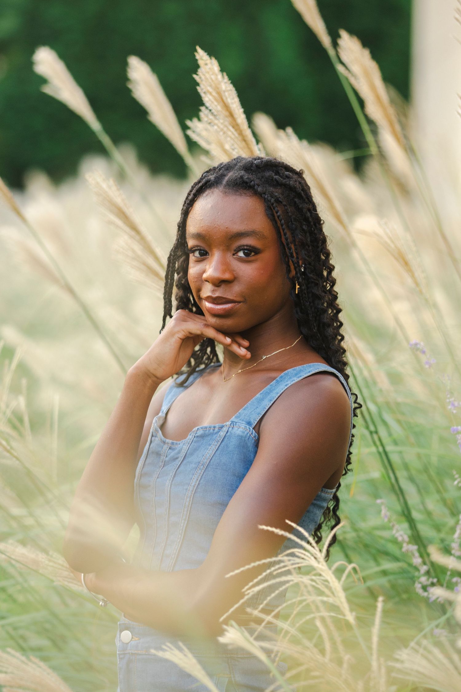 senior session of girl in denim top surrounded by tall grass