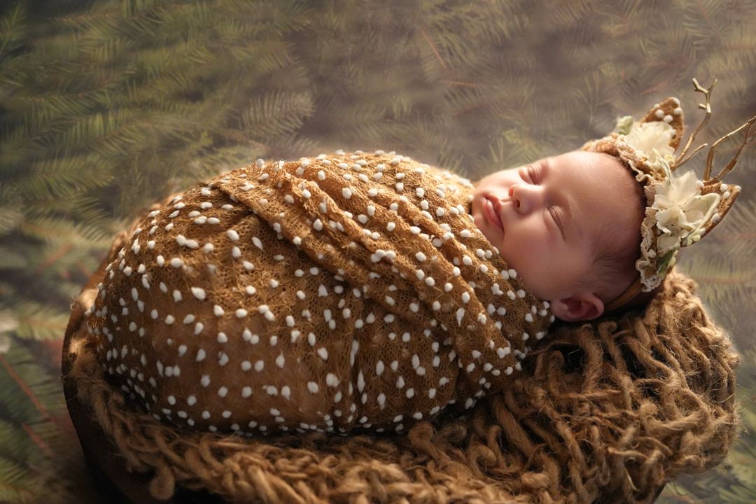A series of photos showing a sleeping baby wrapped in brown fabric with white spots creating a deer-like pattern.