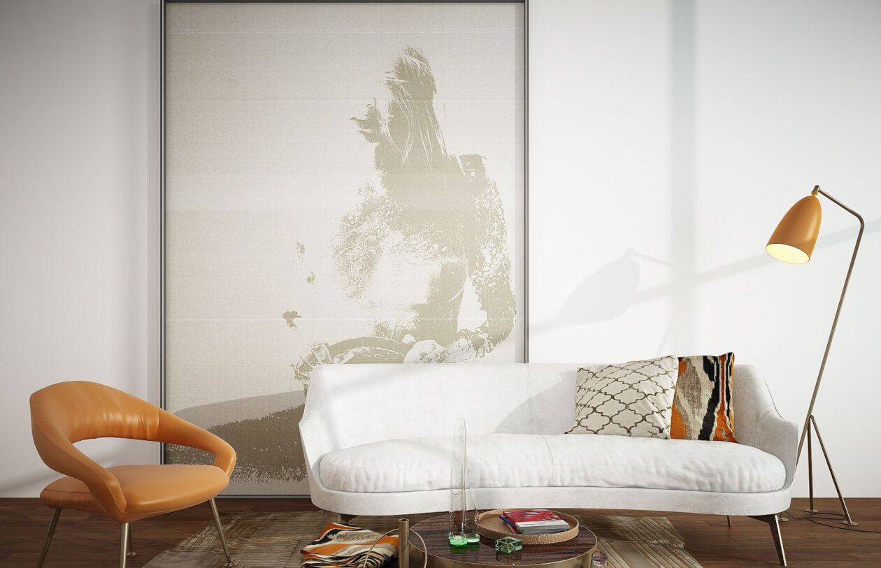 Minimalist living room with abstract wall art, curved orange chair, and white sofa.