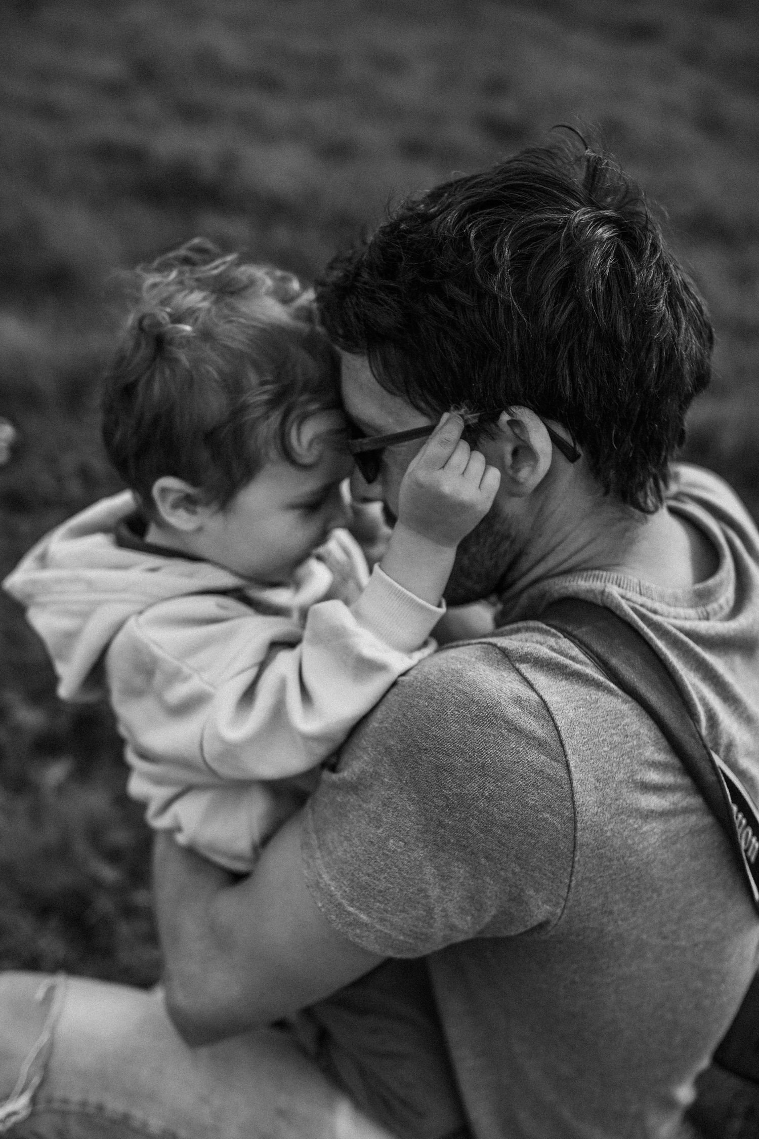 A tender black and white moment between parent and child outdoors.