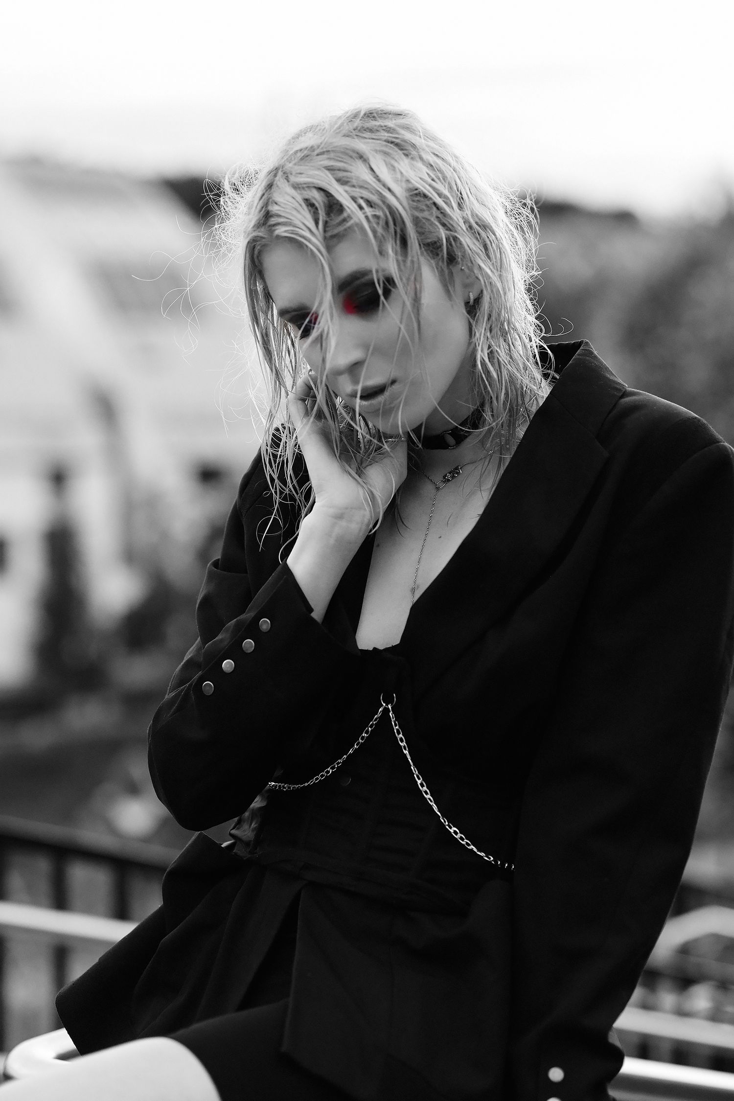 Black and white close-up portrait of a blonde girl with contrasting makeup. Pink eye shadow
