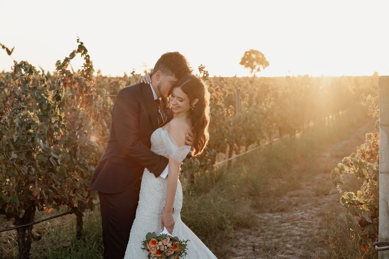Sunset portrait in a vineyard with warm golden light filtering through.