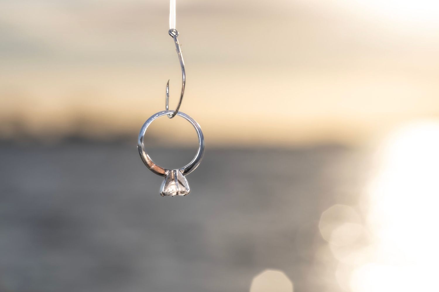 A playful couple shares a fun moment as one person is lifted up outdoors.