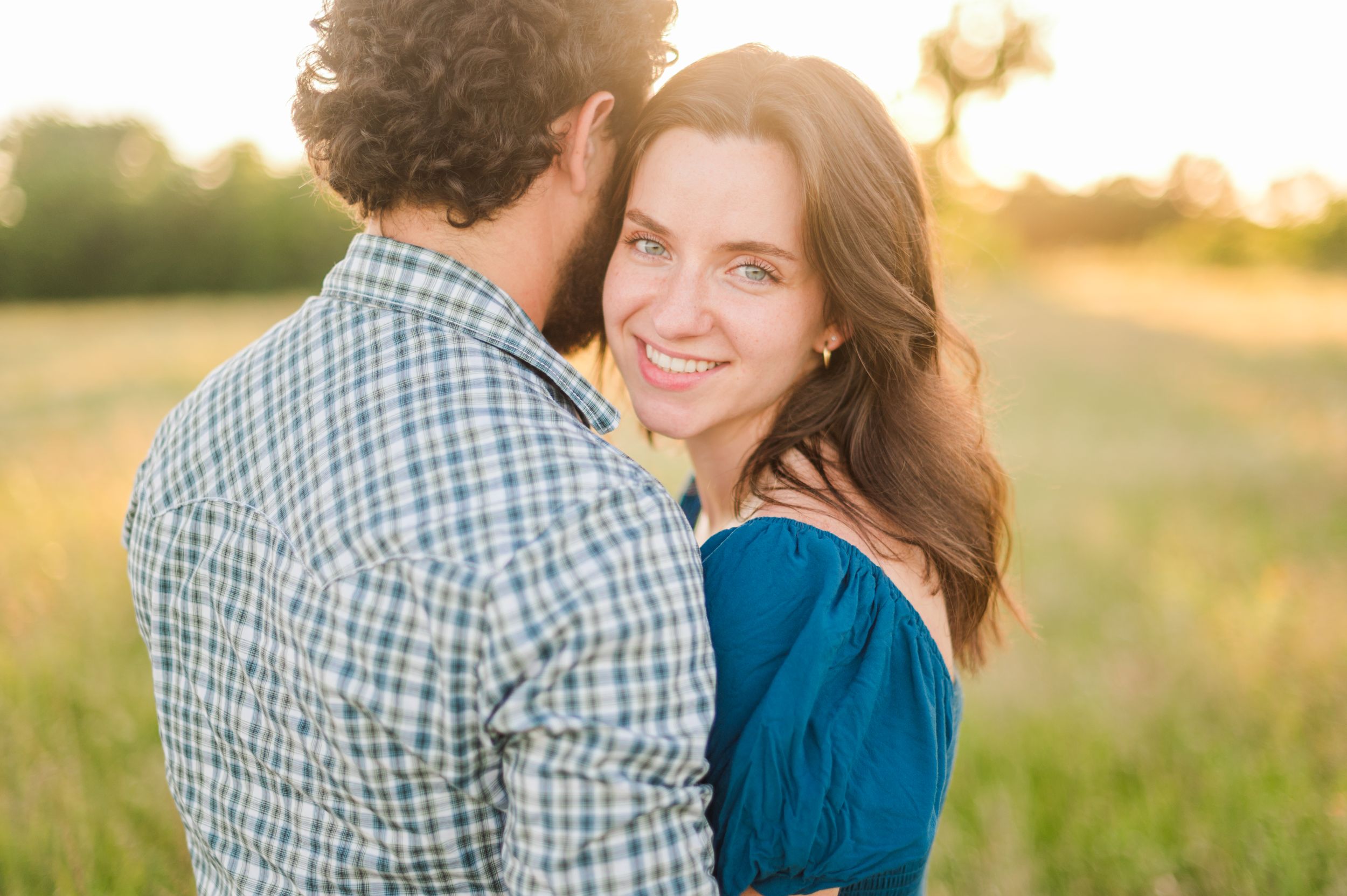 Sunny summer time engagement session in a field in Tulsa, Oklahoma.