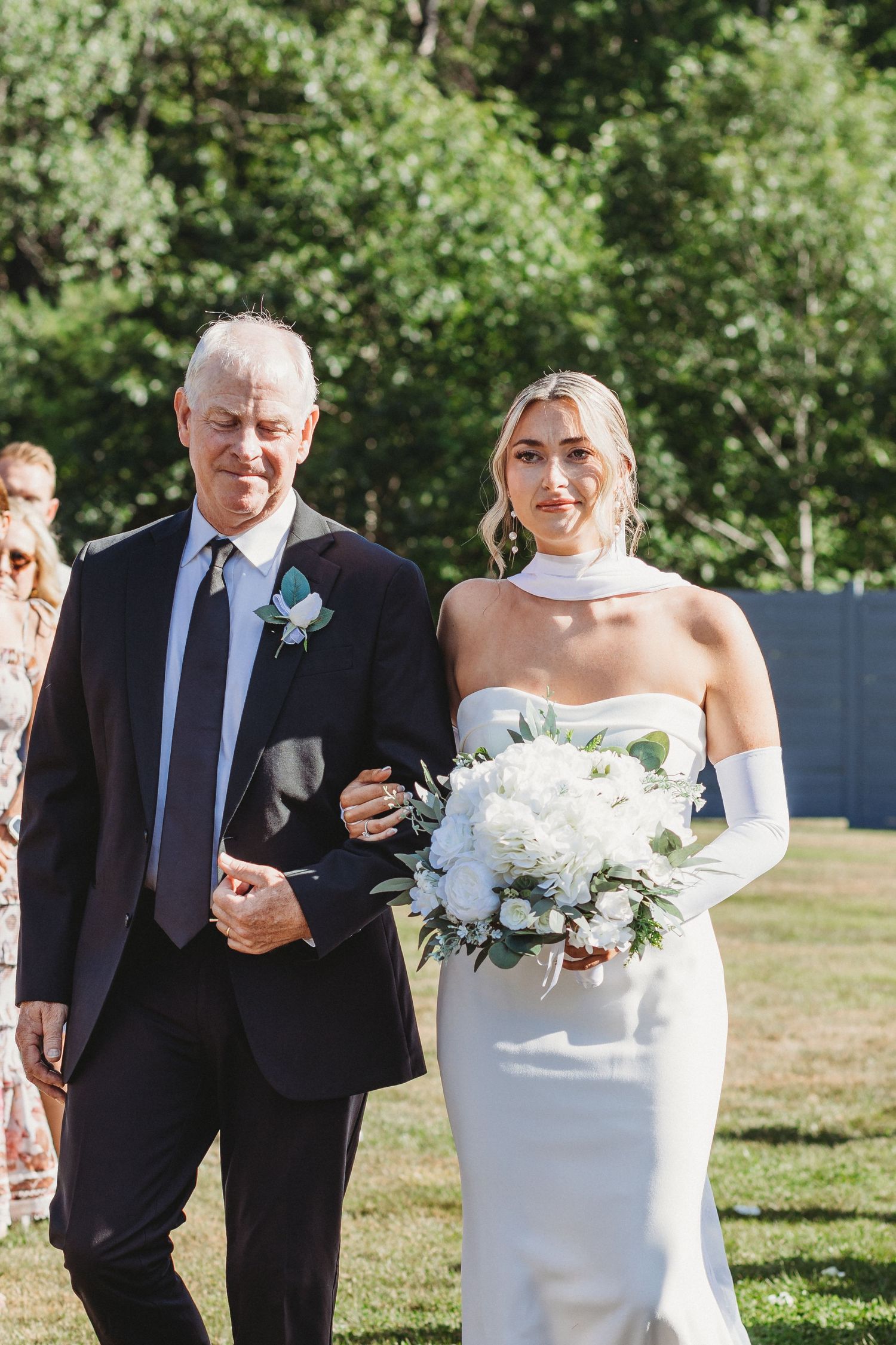 father walking bride down the isle on very sunny wedding day