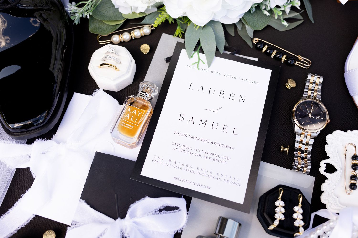 wedding flat lay image with a black and white wedding with gold accents