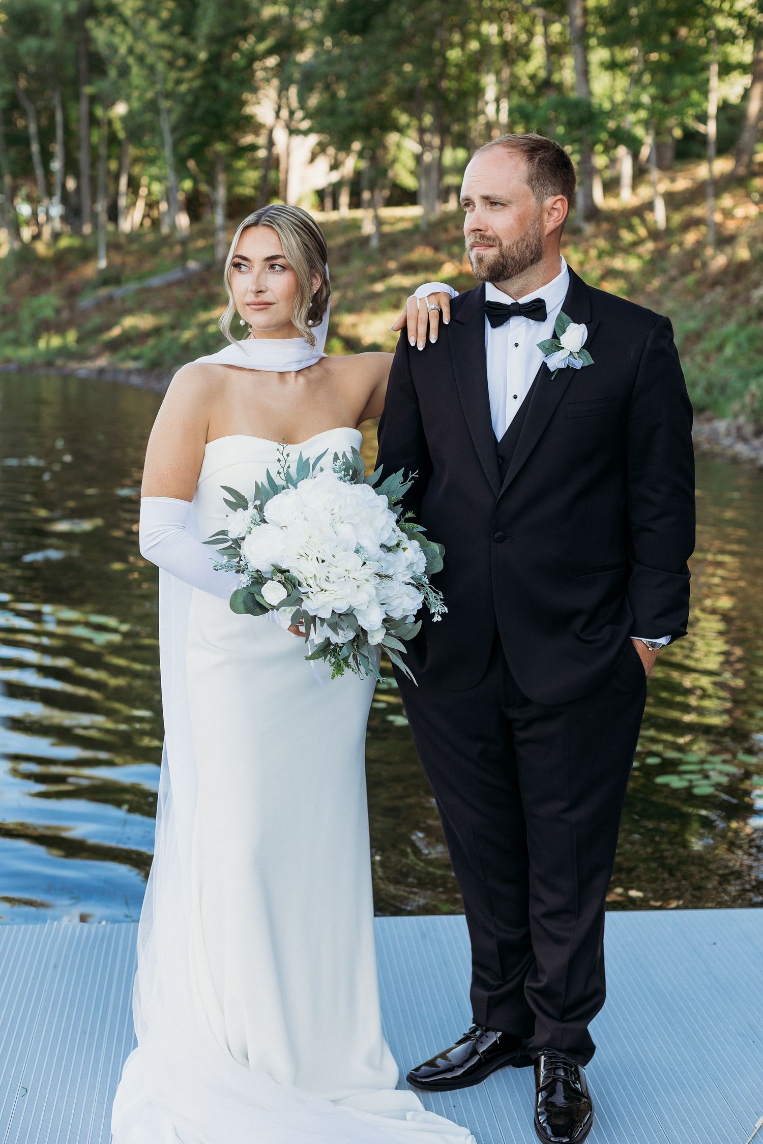 bridal couple photo done by a dock at a maine wedding venue capturing the scenery