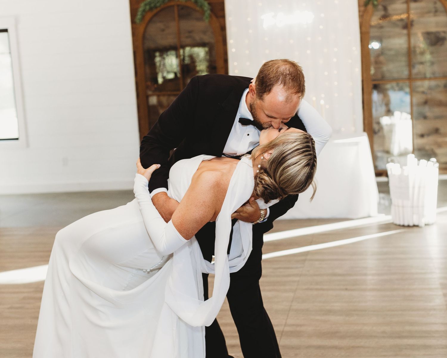 photo of the first dance where the groom dips the bride.
