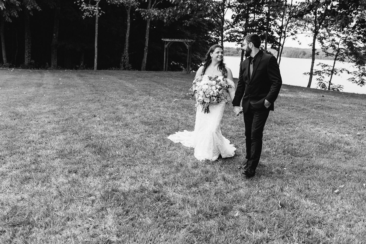 maine wedding photographer capturing lakeside ceremony at maine wedding venue with photos of bridal couple