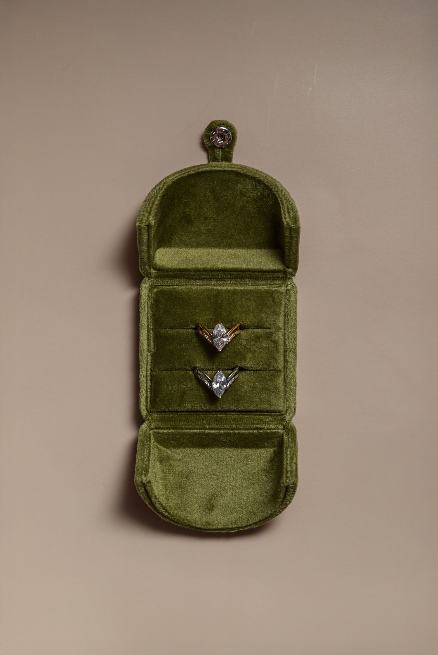 Sequence of photos showing a green velvet ring box with diamond engagement ring opening and closing against beige background.