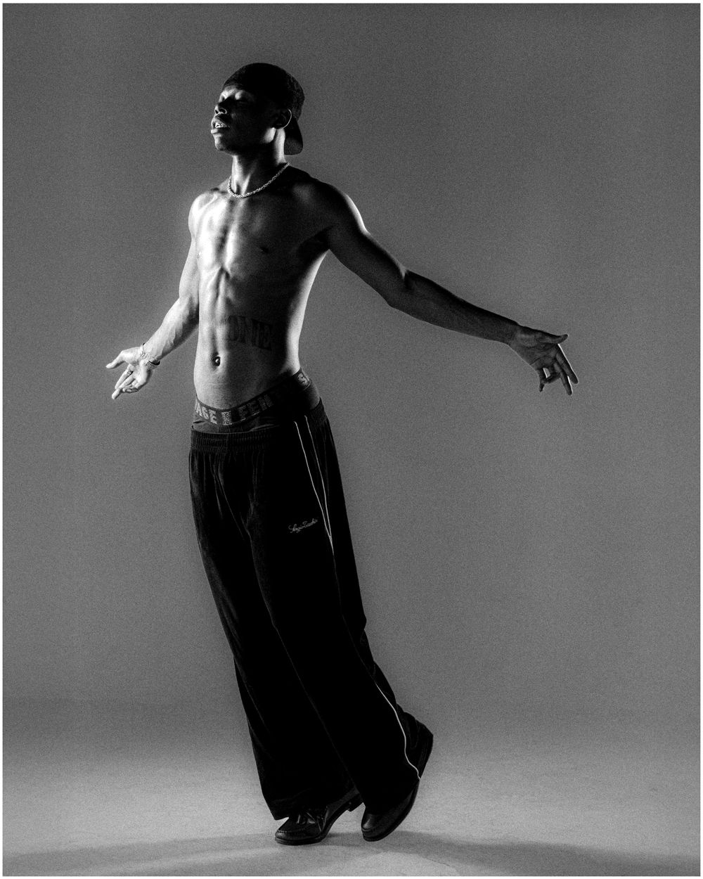 A sequence of black and white photographs showing a dancer in fluid motion against a simple background.