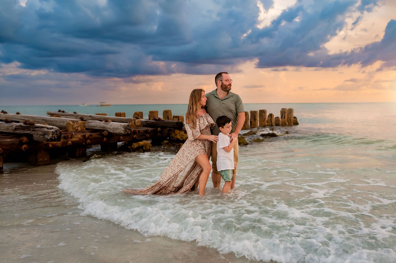 Family embracing on Anna Maria Island beach at sunset