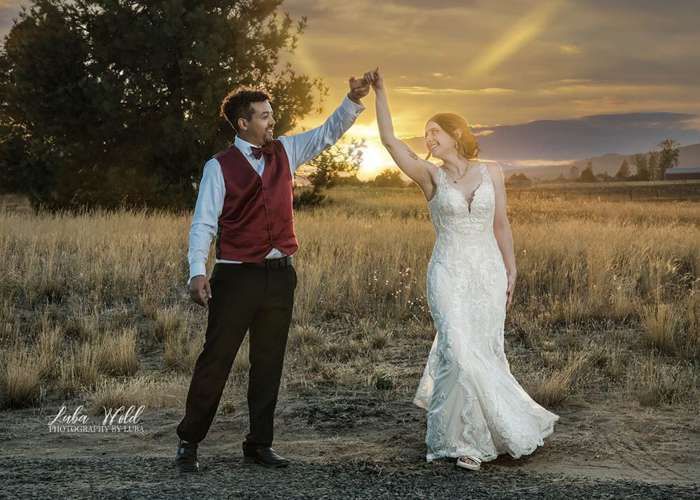 Spokane wedding portrait of a bride and groom dancing at a sunset by photographer Luba Wold