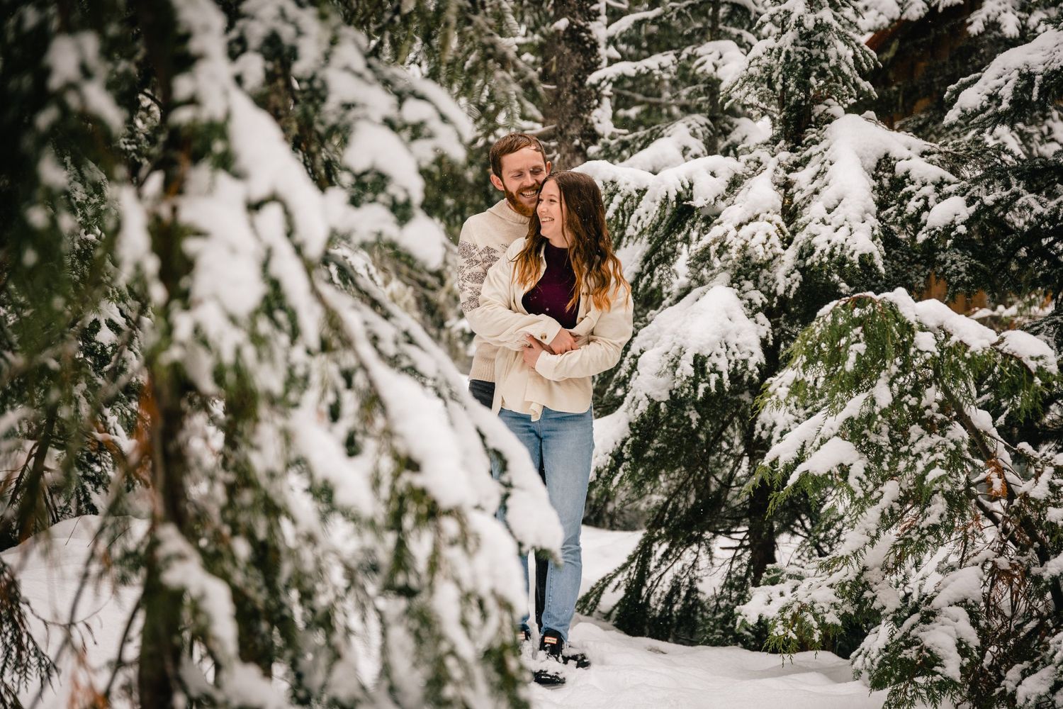 A winter portrait among snow-covered evergreen trees in a forest setting in Government Camp and Mount Hood in Oregon.
