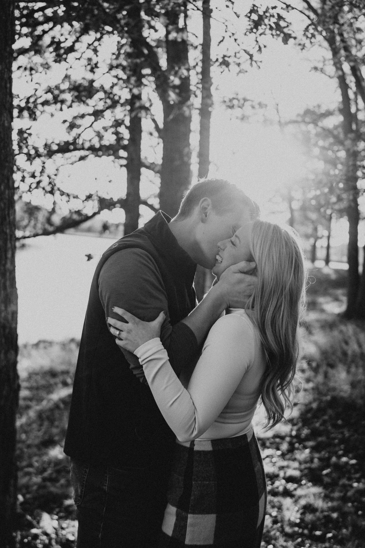 A couple in love kissing at sunset.