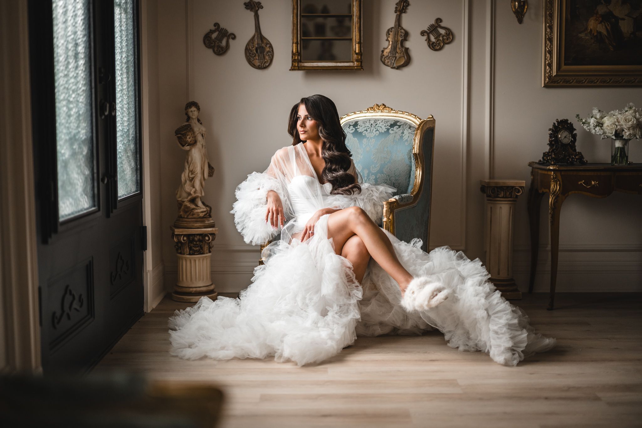 editoral style portrait of the bride sitting in the bridal suite with a long elegant robe at the conservatory at blackberry ridge