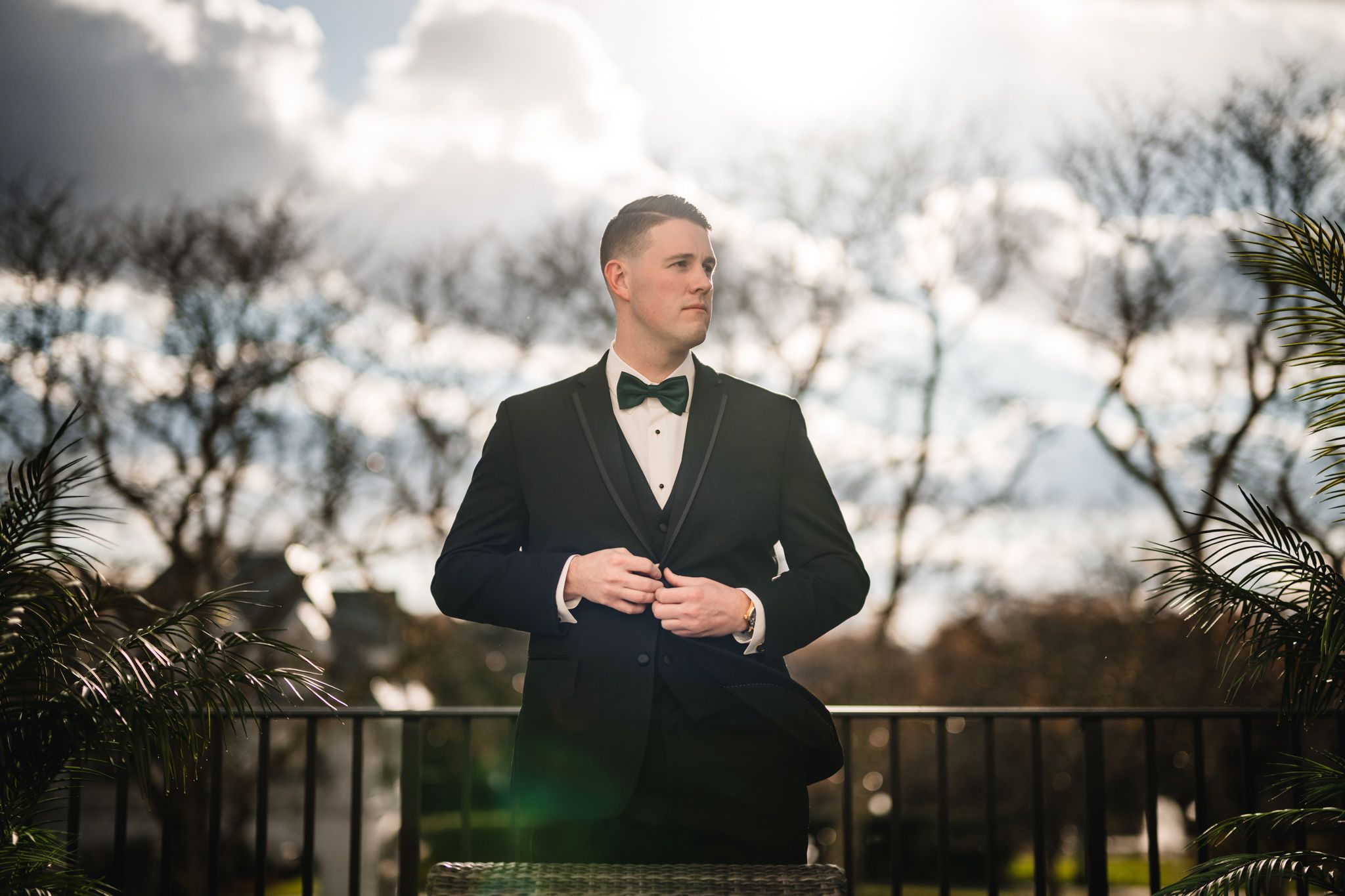 dramatic outdoor groom portrait on the balcony at the chateau grand hotel Park chateau wedding