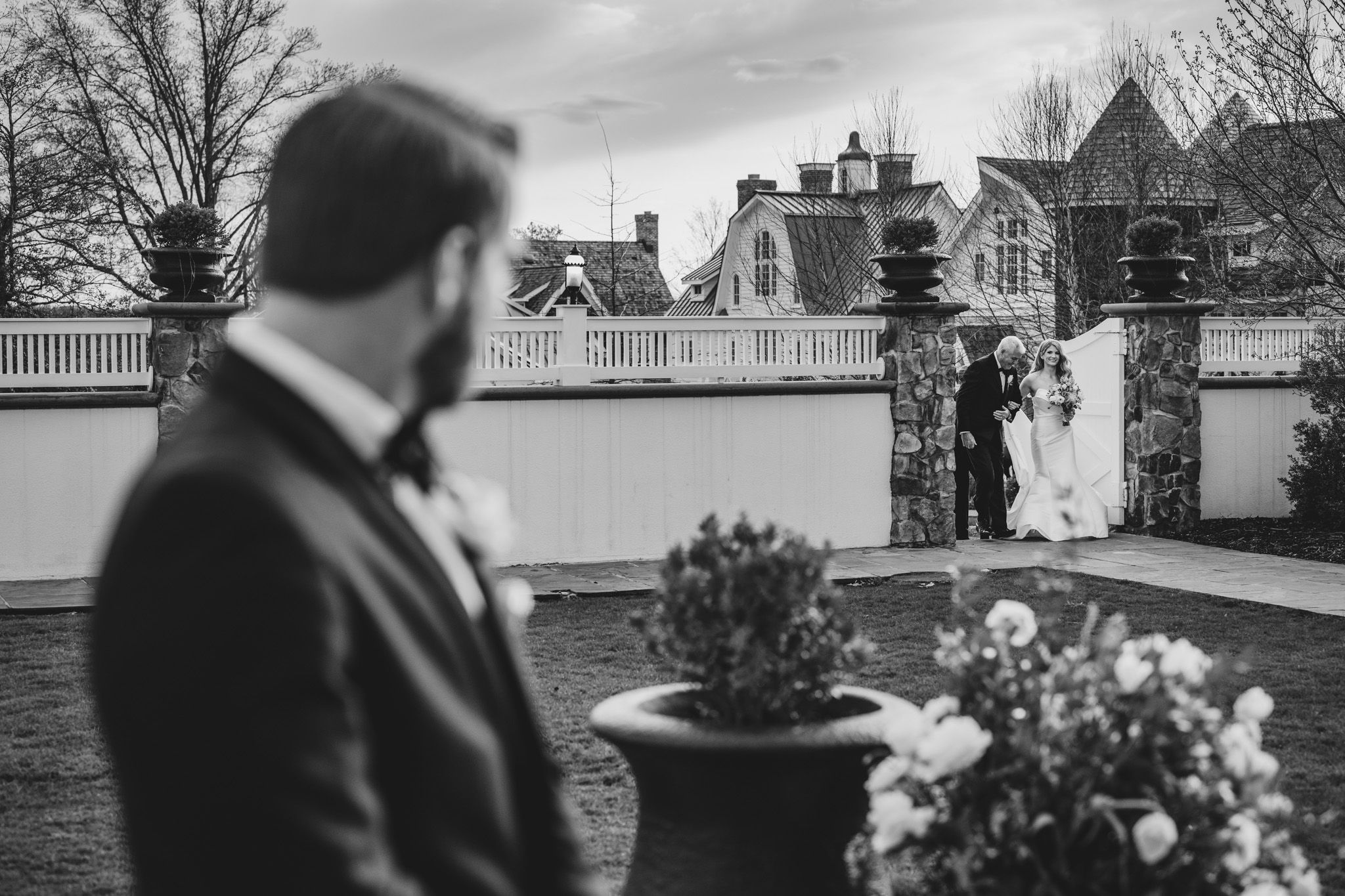as the wedding begins groom sees his bride enter the outdoor ceremony at the ryland inn