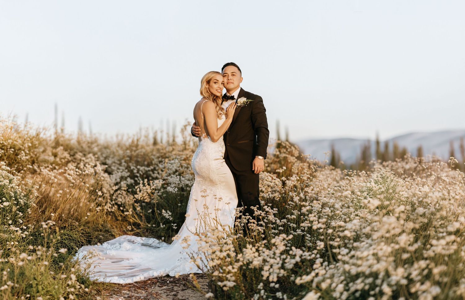 Gabriella and Paul posing among wildflowers at Falkner Winery in Temecula