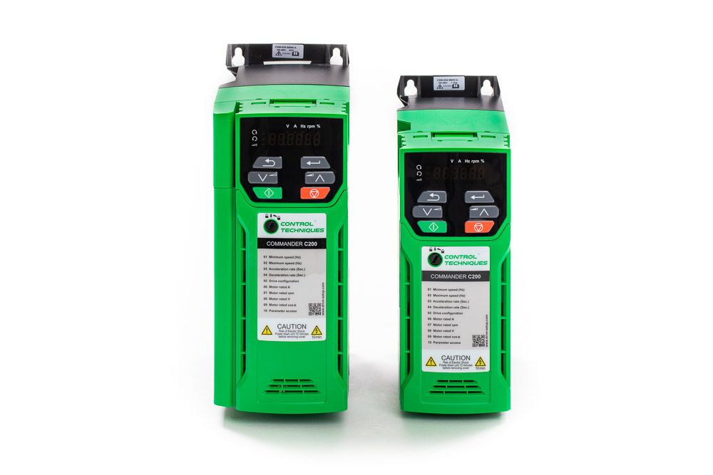 Two green variable frequency drives side by side, showing control panels with displays and buttons for industrial motor control.