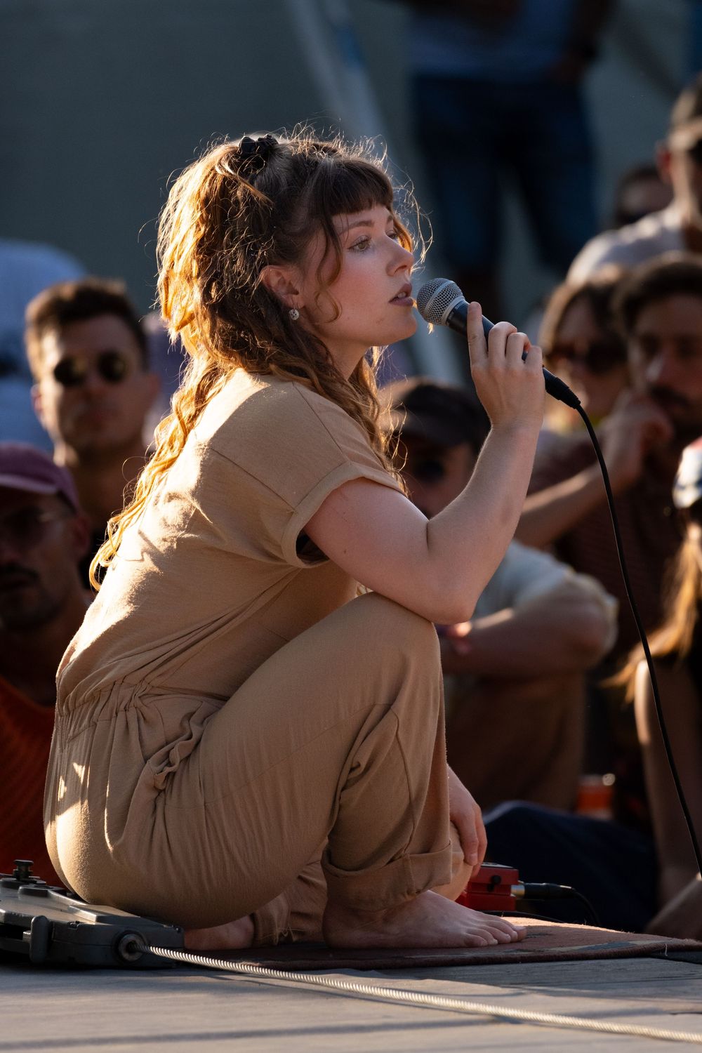 Artiste chantant au milieu du public lors d'un spectacle de rue.