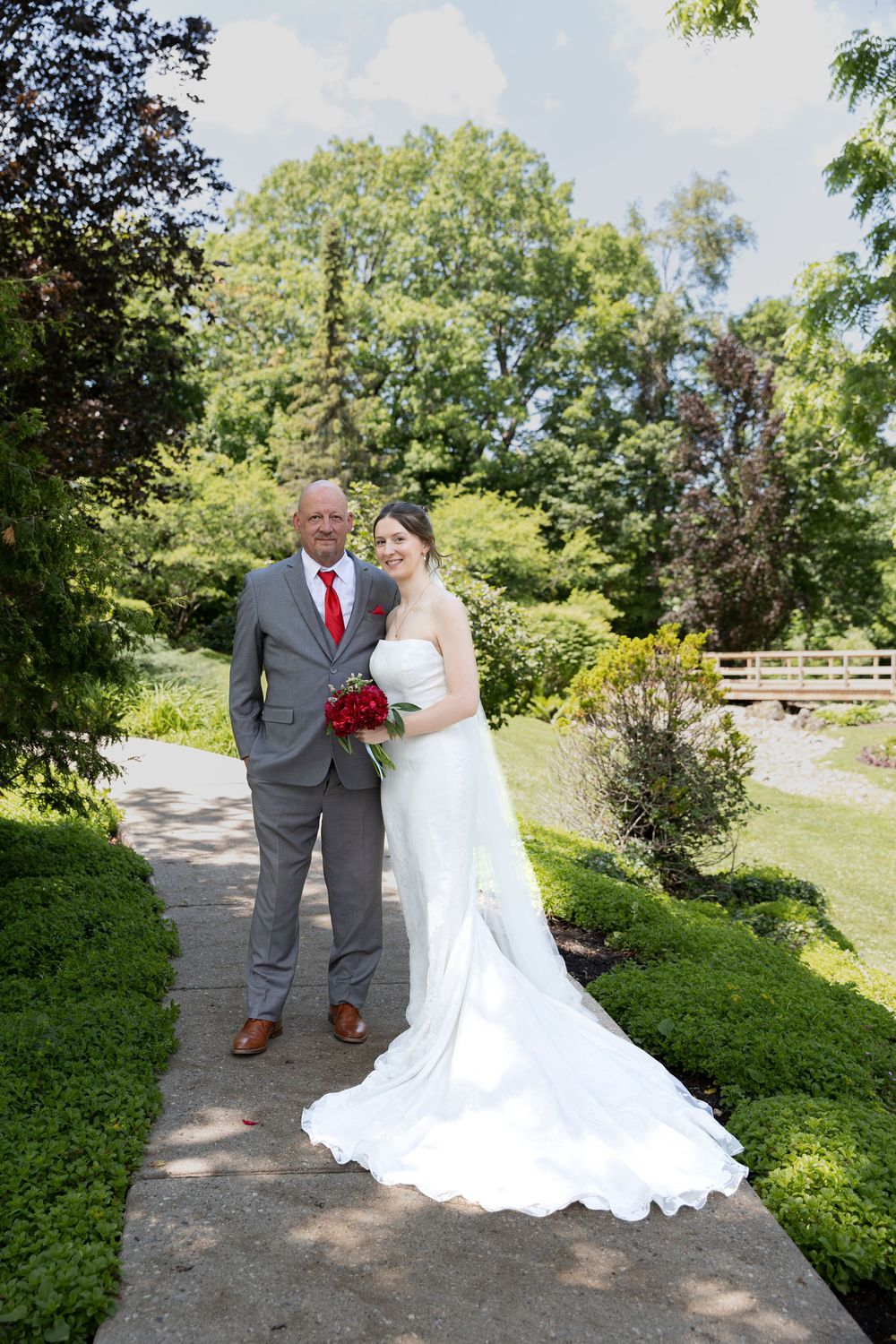 Bride and father stand together during first look surrounded by greenery at the civic garden complex in london, ontario.