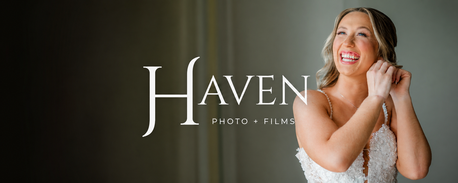 Bride in lace wedding dress adjusting jewelry, smiling, with Haven Photo and Films logo overlay.