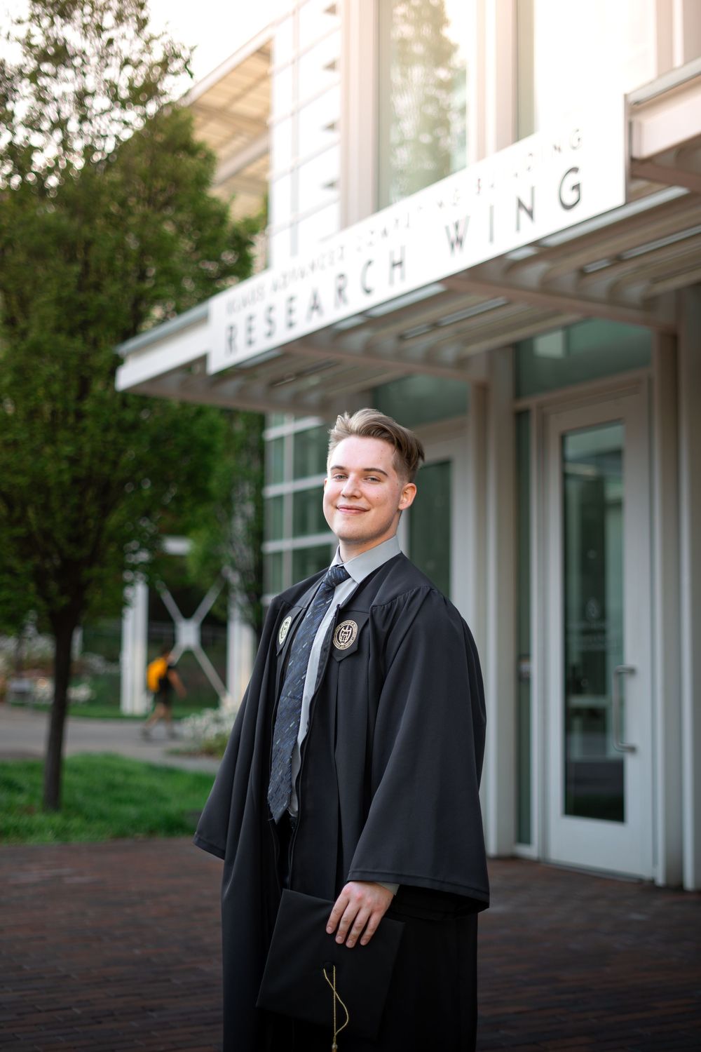 Smiling graduate poses for the best Atlanta grad photos at Georgia Tech with portraits by Pierre The Pear Photography
