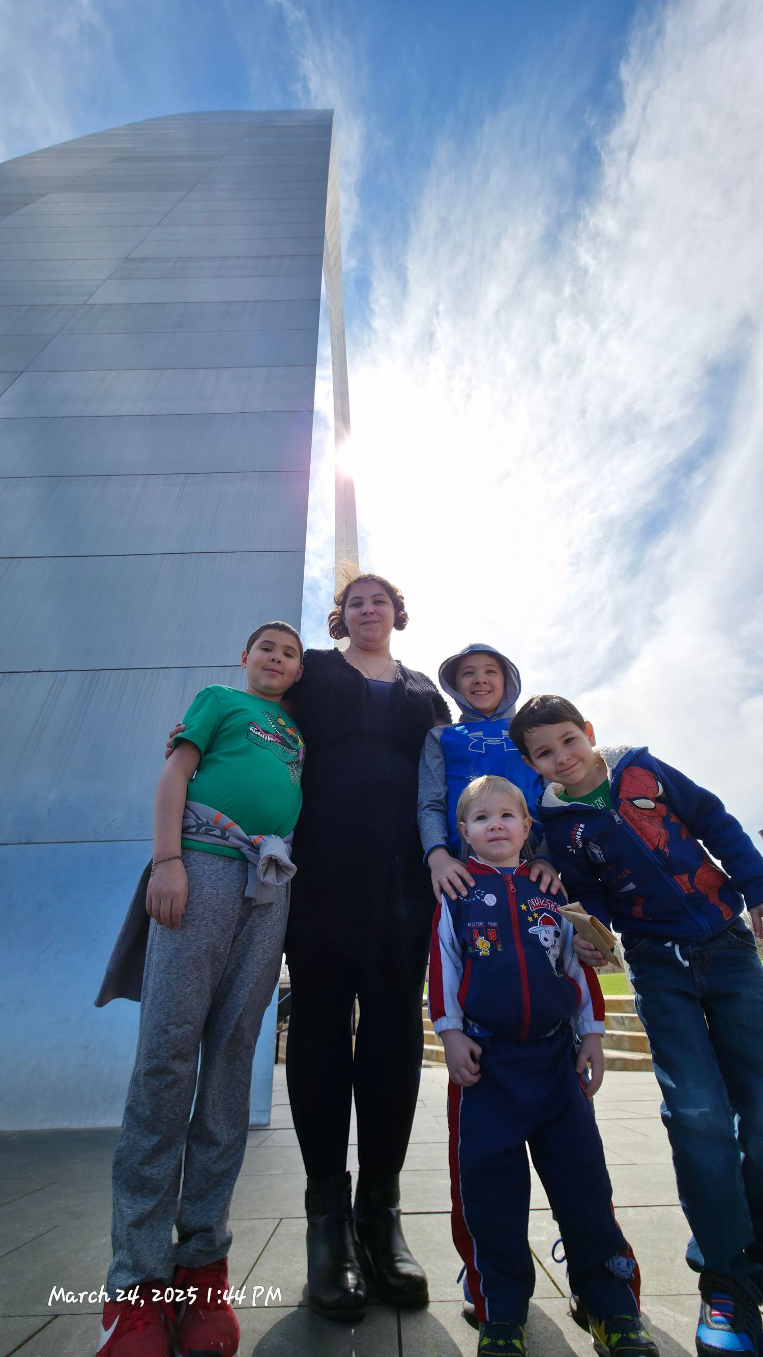 Family visiting Gateway Arch National Park during a family vacation in St. Louis.