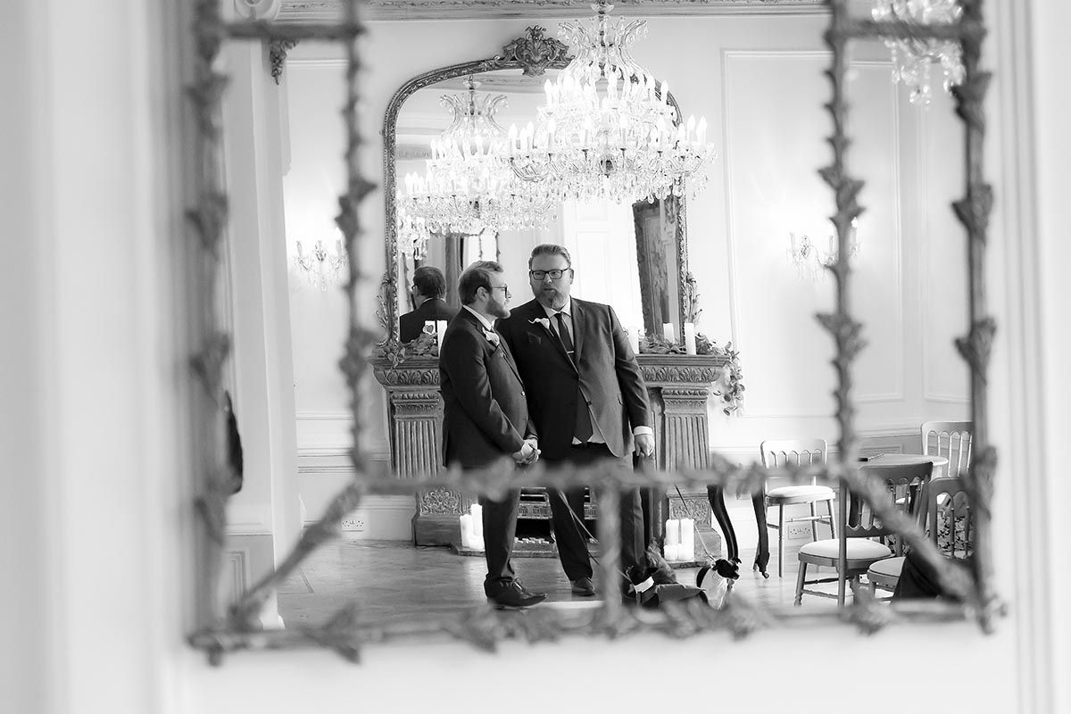 Groom & best man conversing in the marriage room Auchen Castle
