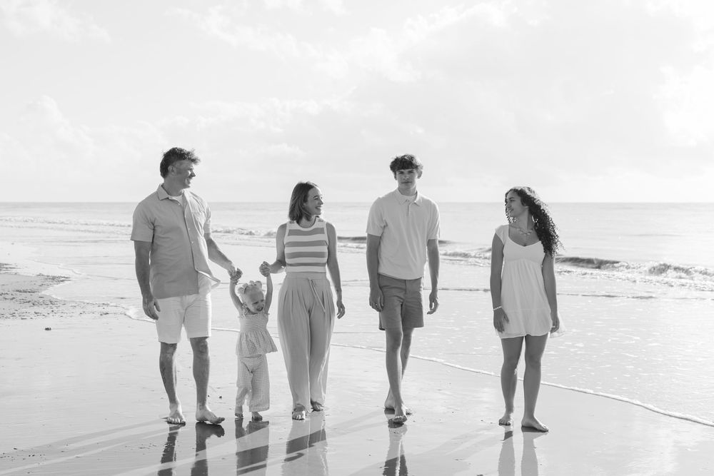 Parents with two teenagers and a toddler on the beach at Jekyll Island, Georgia at a family photo session while they vacation on Jekyll