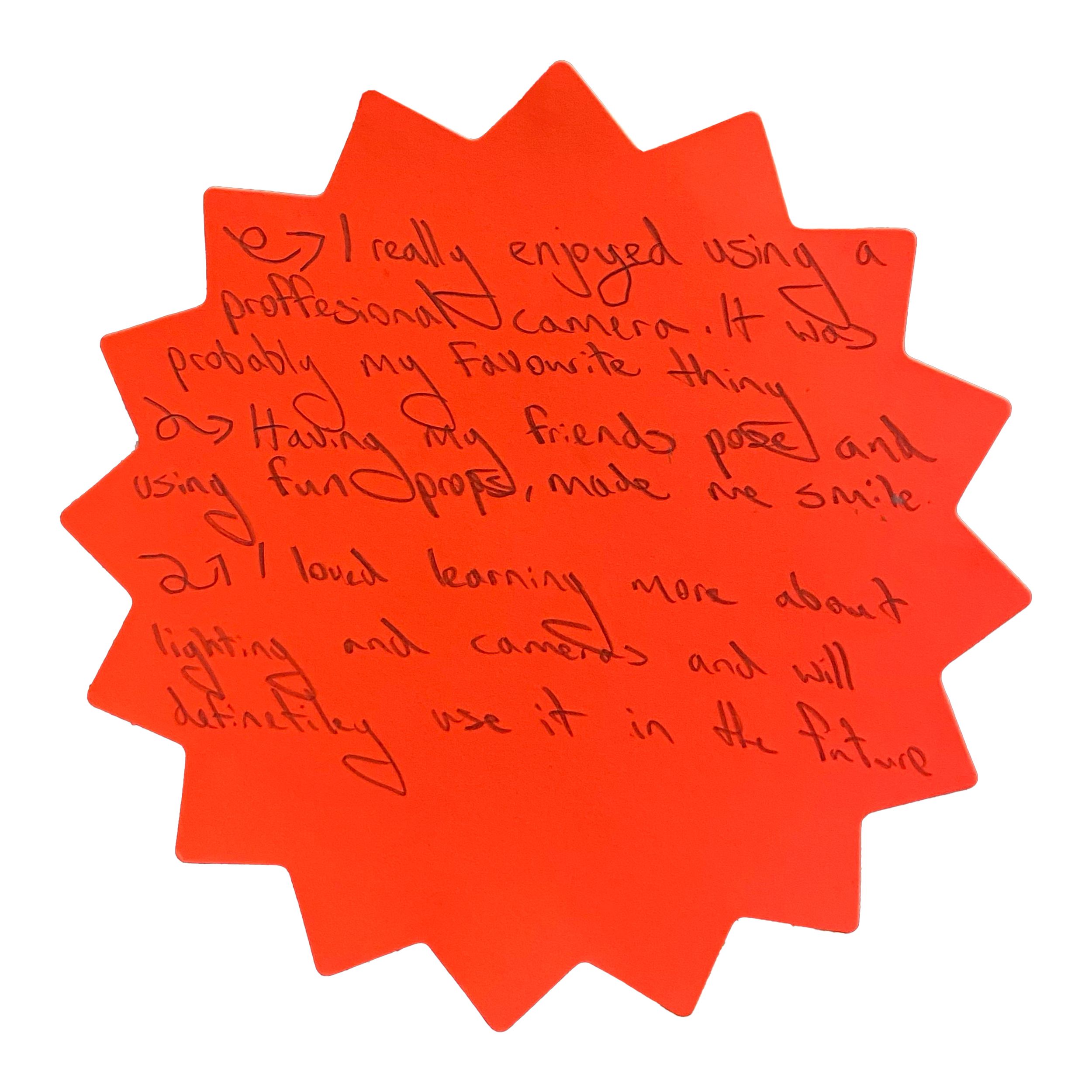 Orange starburst sticky note with handwritten feedback about enjoying a professional camera, friends' poses, and learning about lighting.