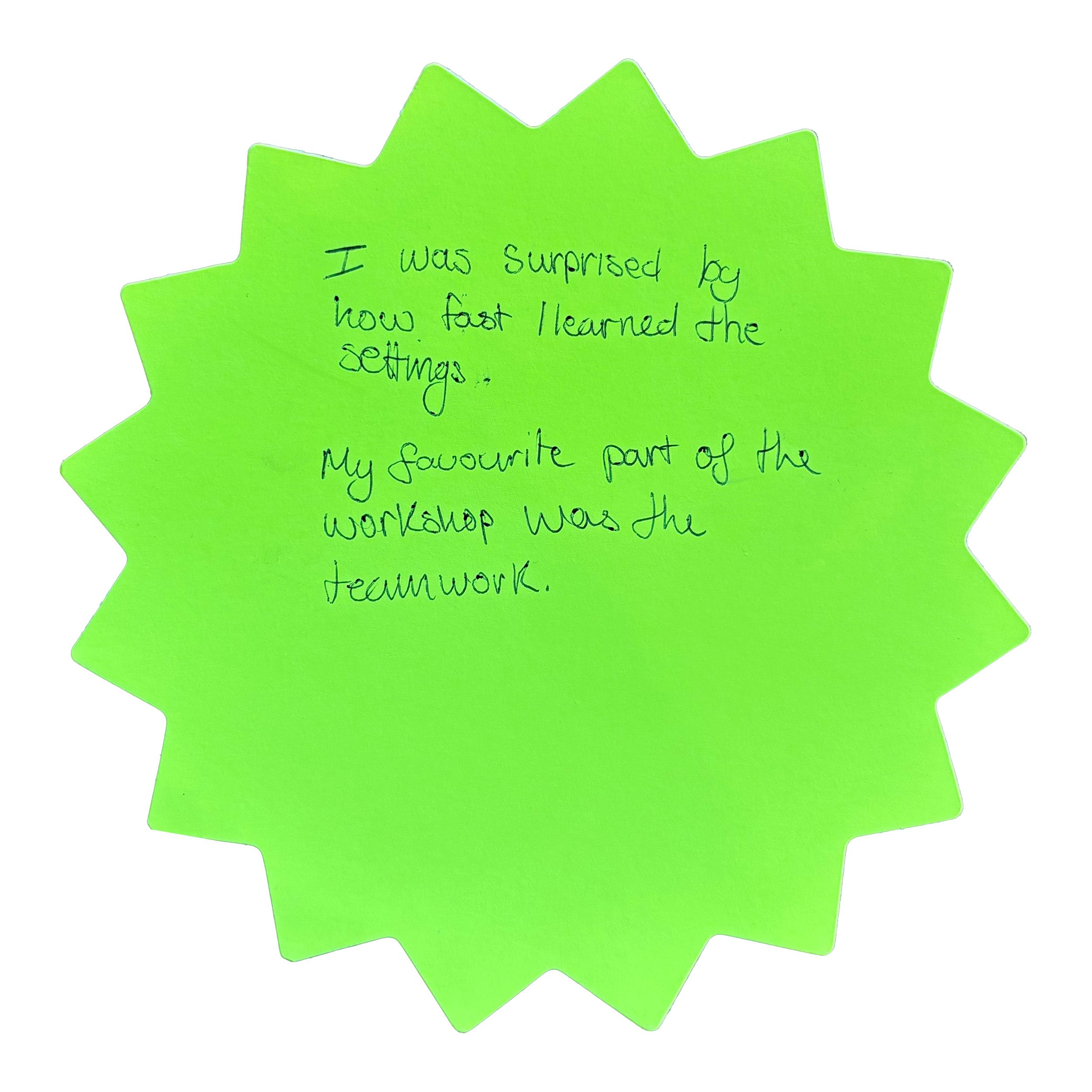 Green starburst-shaped note with handwritten workshop feedback about learning the settings quickly and enjoying the teamwork.