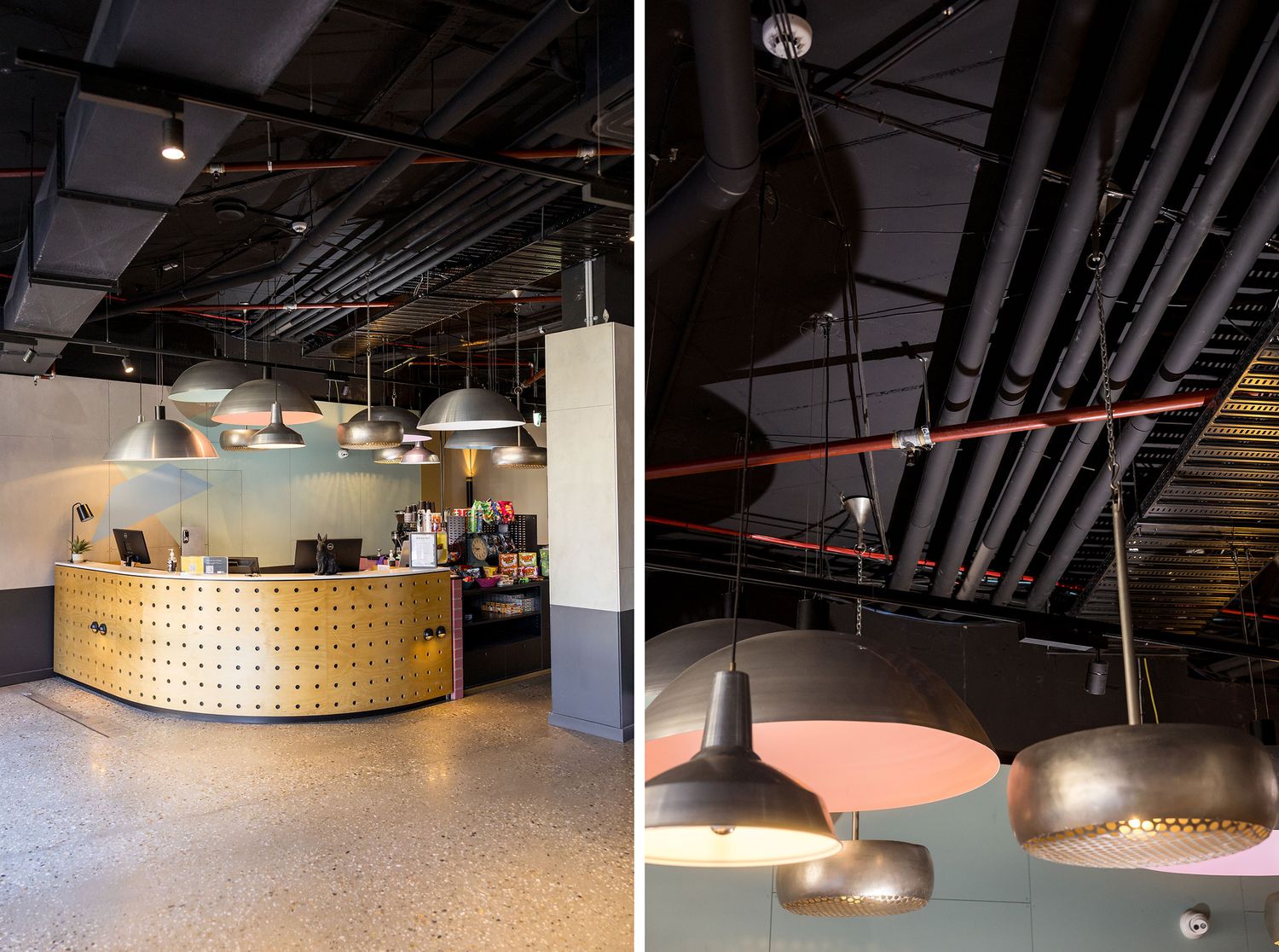Modern industrial bar lounge with exposed black ceiling, pool table, pendant lights, and colorful geometric wall accents.
