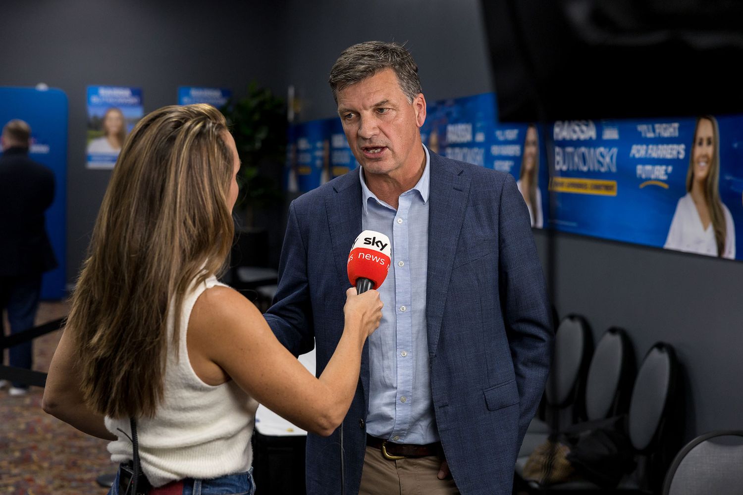Angus Taylor Liberal Leader being interviewed by  journalist Laura Jayes holding a red SKY News microphone at a political event.