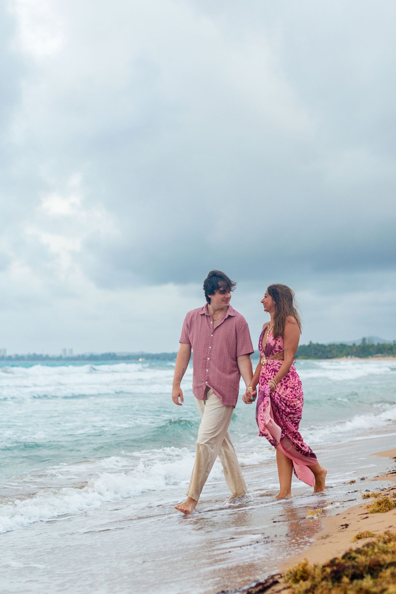 Couples portrait on the beach. Walking at the water's edge. Río Grande, Puerto Rico.