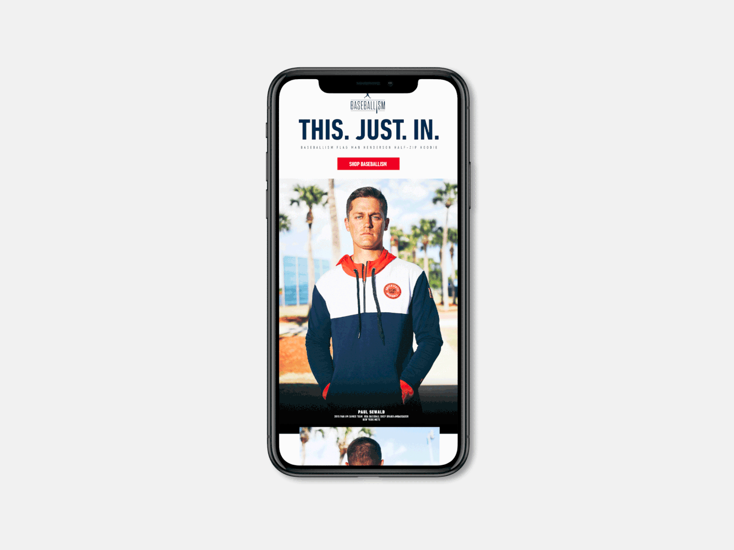 Mobile phone displaying a sports apparel ad with a man wearing a navy hoodie and the text THIS. JUST. IN.