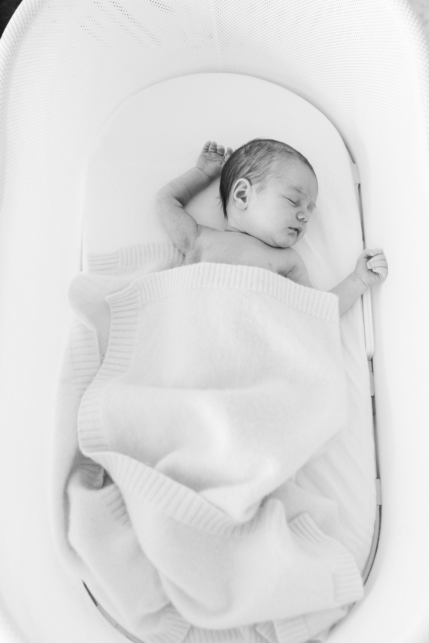 Black-and-white portrait of a newborn asleep. In-home lifestyle newborn session in Guaynabo, Puerto Rico.