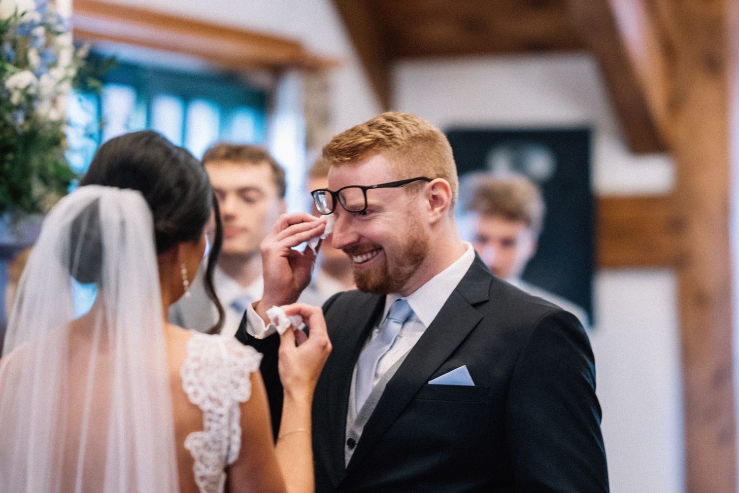 Groom wiping away a tear during the ceremony at The Post Hotel