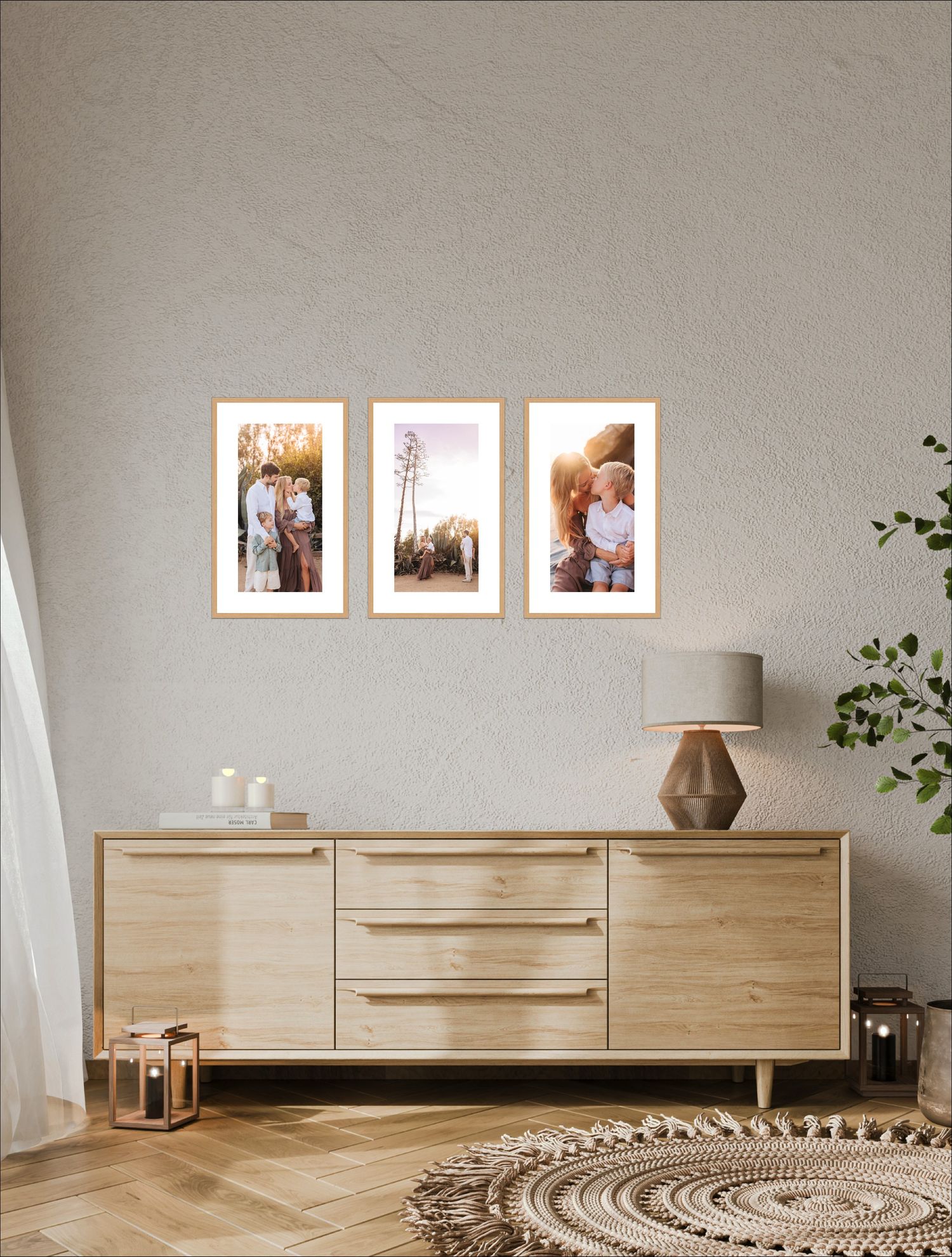 Three framed family photos hang on a textured gray wall above a light oak sideboard with a table lamp, lanterns, and a woven jute rug.