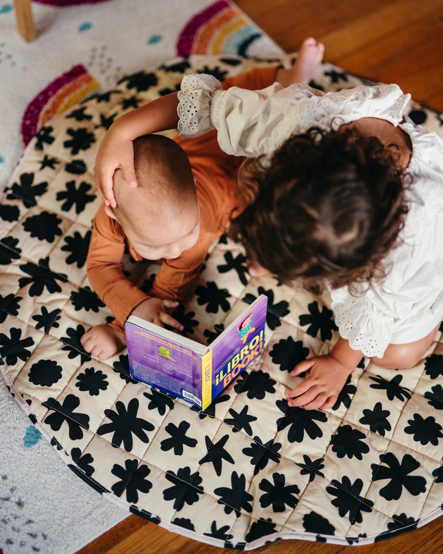 Older sister reads to her younger brother