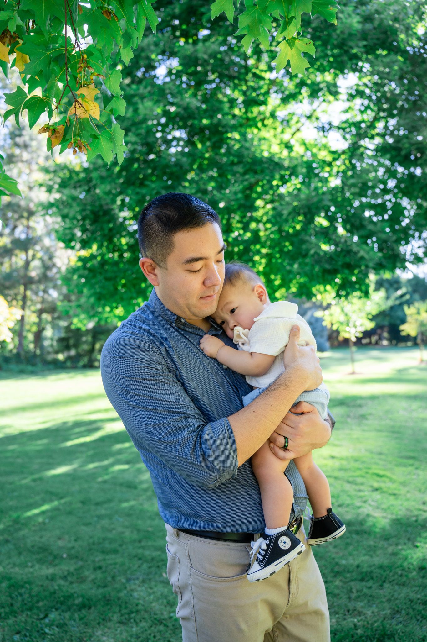 Young boy takes a break to snuggle with dad during a photos session