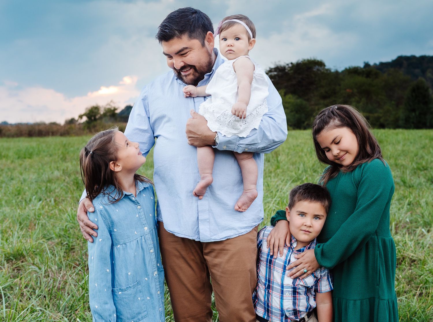 Western North Carolina family portrait session with coordinated earth tone outfits, Smoky Mountains backdrop"