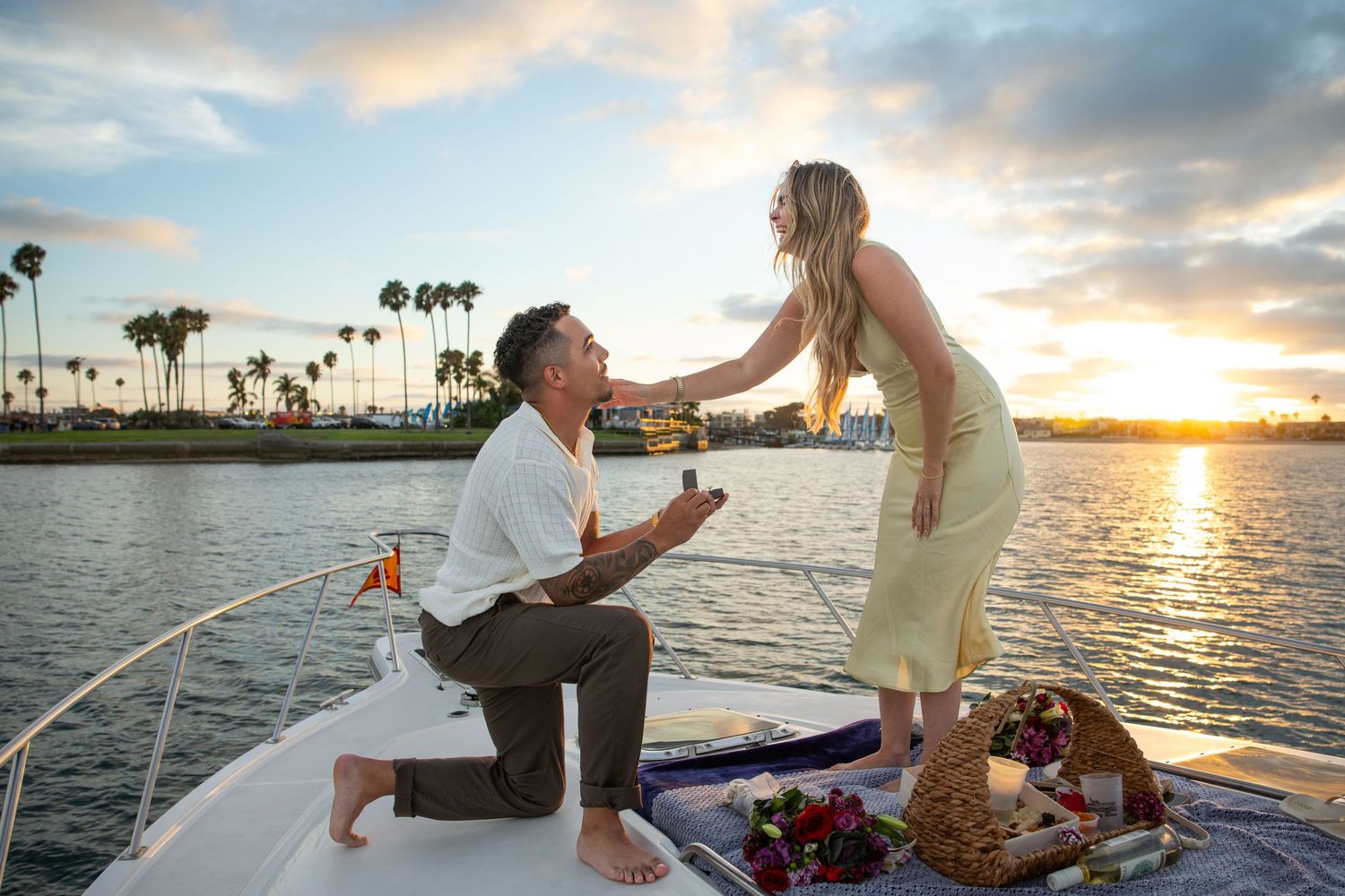 Surprise marriage proposal at Sunset Cliffs in San Diego, featuring a man on one knee proposing to a woman overlooking the ocean.