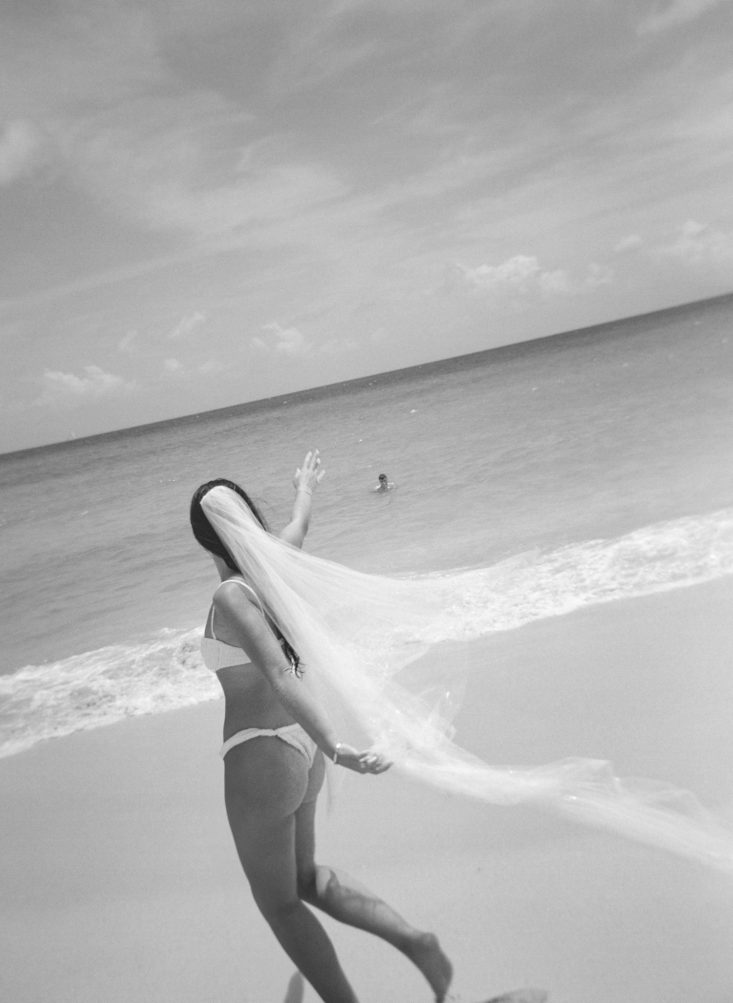 A white wedding dress shows a dramatic ombre effect transitioning from pristine white to smoky grey at the bottom.
