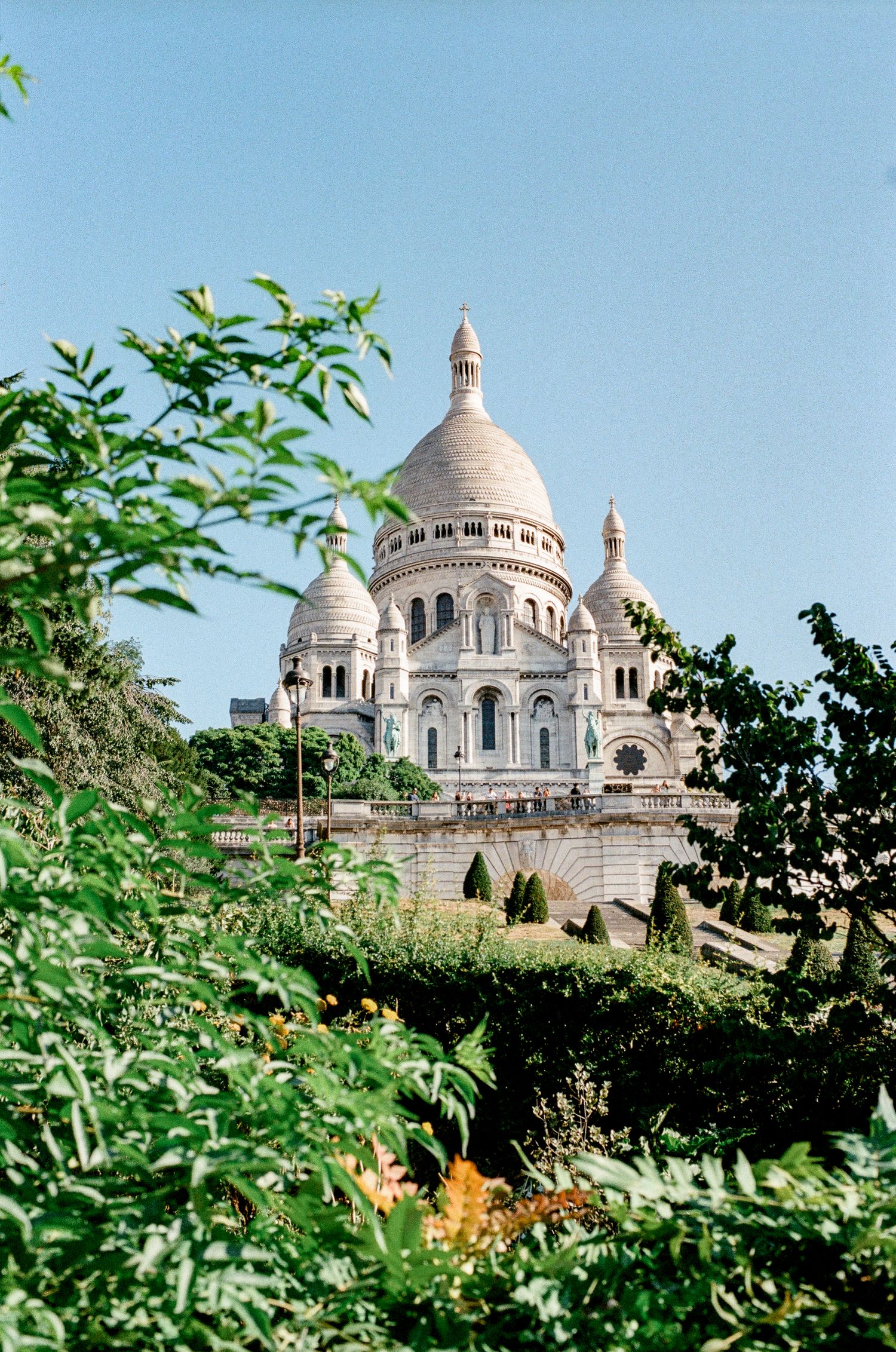 Interior of Sacré-Cœur Basilica in Paris, featuring stunning mosaic apse, ornate altar, and wooden pews.