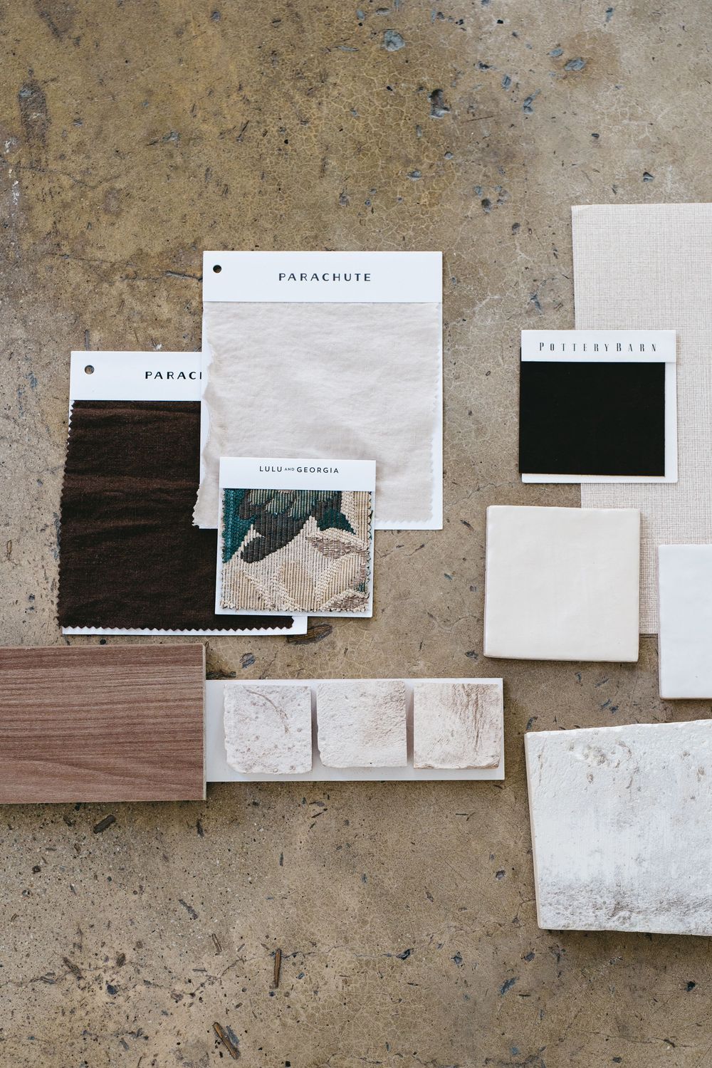 a layered arrangement of tile, wood samples, and fabric textiles