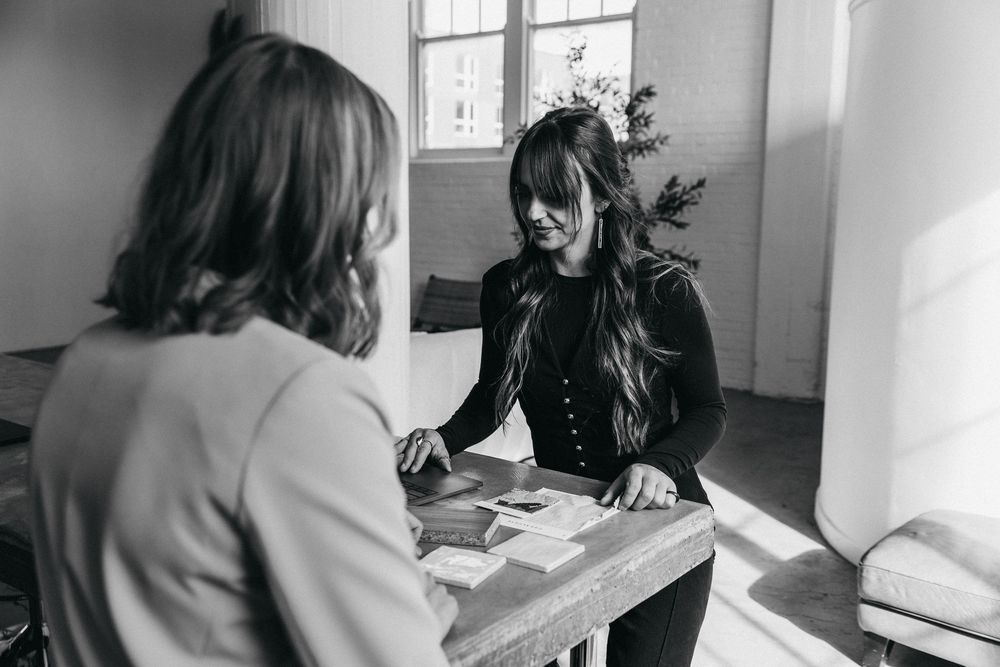 an interior designer reviewing textile samples with a client