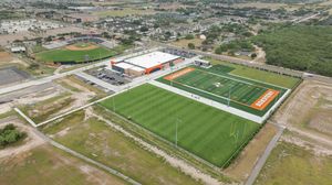 Aerial view of UTRGV Vaqueros athletic complex with soccer fields and sports performance center.